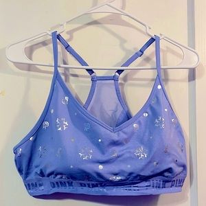 PINK. Light sports bra, purple with silver stars and pink logo.